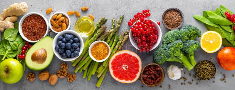 Healthy food background with fresh salmon fish, vegetables, berries and nuts. Top view. Banner. Closeup. Healthy food background with fresh salmon fish, vegetables, berries and nuts. Top view. Banner. Closeup